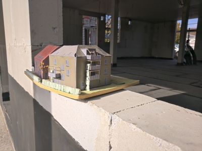 Ein Modell der Häuser steht auf einem leeren Fenstersims